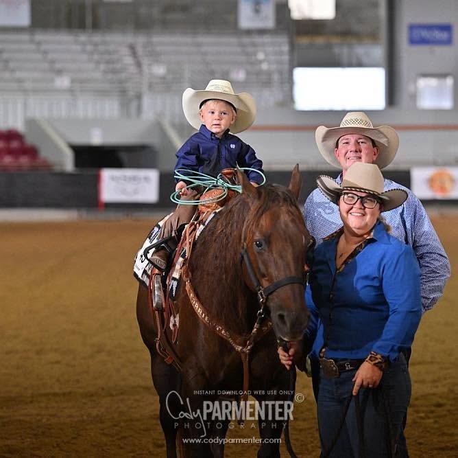 Family at rodeo — young cowboy on horse